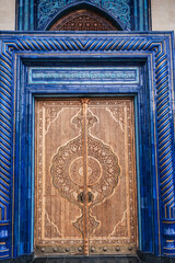 Wooden door with carved oriental pattern Uzbek ornament in the Museum of Victims of Political Repression in Tashkent