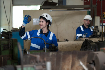 Group of engineer working together in industry factory, wearing safety uniform, safety helmet
