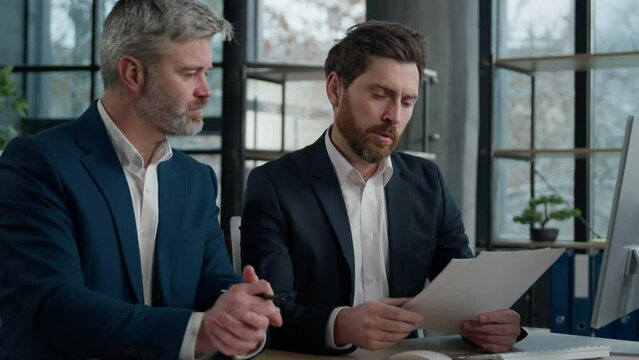 Caucasian men businessmen discussing agreement business documents in office dissatisfied leader employer disappointed with failed contract problem deal colleagues partners upset bad news tax penalty