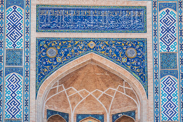 ancient ceramic tile with a traditional Arabic pattern Uzbek ornament decorates the portal of the...