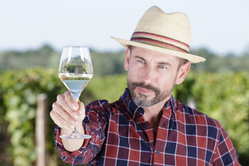 winegrower with wine glass in the vineyard