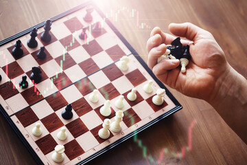 Black and White chess with player, Businessman and Businesswoman shaking hands after end game of...