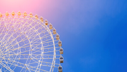 white ferris wheel on background a clear blue sky in Navruz Park in Tashkent with copy space