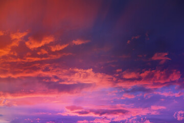 Beautiful sunset sky above clouds with dramatic light. Cabin view from airplane