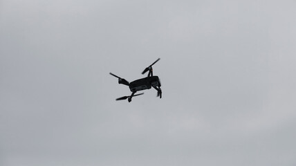Drone against the sky. Copter in flight.