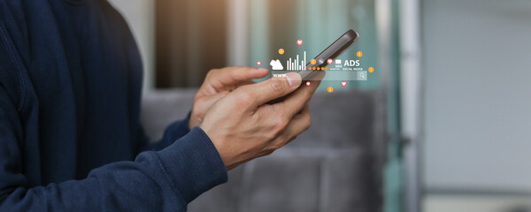businessman hand touch screen on smartphone to checking traffic research of pay per click program on web page after announce special campaign on holiday for marketing tool online business concept
