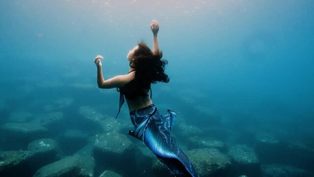 professional freediving mermaid girl no mask dancing in blue water showing beautiful mermaid costume fishtail Asia Taiwan 