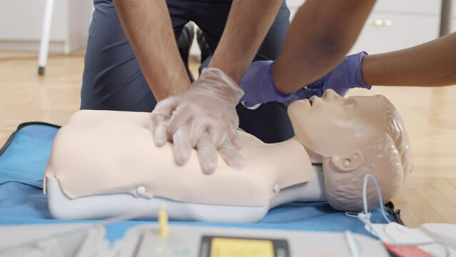 CPR on a medical training dummy in a clinic setting