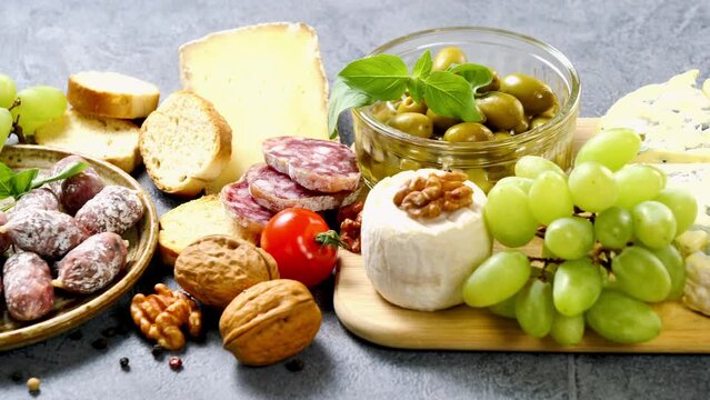 various cheese, salami,nuts and grapes- antipasto, snack