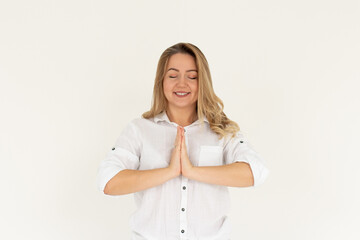 Smiling attractive charming caucasian woman holding palms together pray, smiling friendly showing namaste welcome gesture, inviting asian guests come in