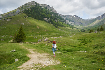 Hiker lady in the mountains on a trail