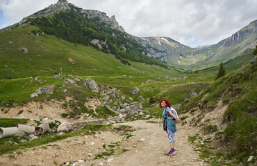 Fototapeta premium Hiker lady in the mountains on a trail
