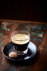 Coffee in glass cup on dark background. Close up. Copy space	