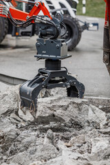Fototapeta premium Construction equipment, crushing machine breaks stones. Construction