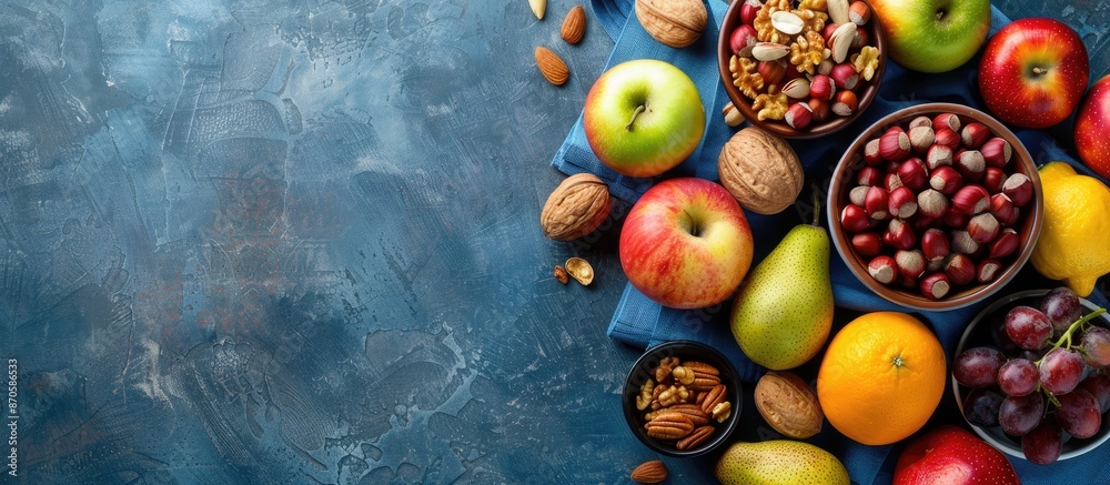 Aufkleber Assorted fresh fruits and nuts displayed on a blue backdrop with copy space image.