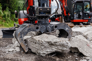 Construction equipment, crushing machine breaks stones. Construction