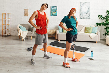 A woman with a prosthetic leg and her boyfriend stretch together on yoga mats in their living room.