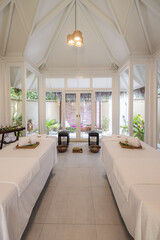 Stylish room interior with massage tables spa salon. Luxury resort hotel couple treatment room massage spa wellness center. Healthcare beauty care, beautiful white design, summer recreational vacation