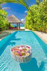 Breakfast in swimming pool, floating breakfast in luxurious tropical resort. Table relaxing on calm...
