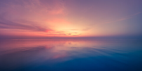 Panoramic sea skyline beach. Amazing sunrise beach landscape. Panorama tropical beach reflection horizon. Abstract colorful sunset sky light tranquil relax summer evening seascape freedom wide angle