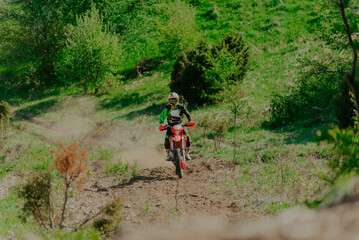 Naklejka premium Professional enduro bike riding dirt road. Motocross sport.