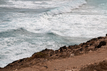 Orange soil and waves of the Atlantic ocean, Lanzarote