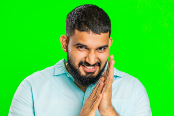Sneaky cunning Indian young man with tricky face gesticulating and scheming evil plan, thinking...