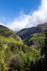 A mountain range with a clear blue sky and a few clouds