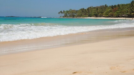 Beach with white sand beach and beach with palm trees  at Sawarna Beach, Banten