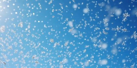 Fototapeta premium Snowflakes Falling in a Blue Sky