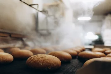 Fototapeten Brot Fresh hot baked bread loafs on the production line  © Roman