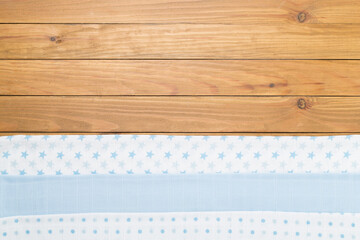 Cotton fabric on wooden background, top view