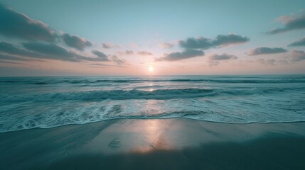Fototapeta premium A peaceful beach with the first light of dawn breaking over the horizon, symbolizing hope and new beginnings.
