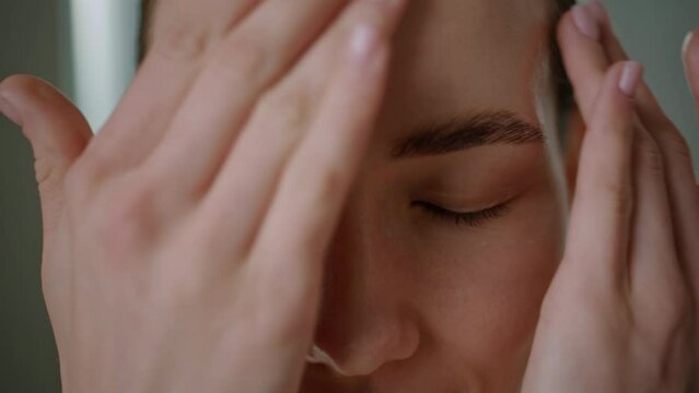 Girl massaging smooth face with moisturizing cream. Closeup beautiful lady rub