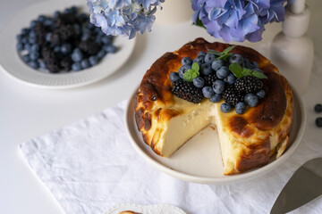 Burnt basque cheesecake decorated blueberries and blackberries