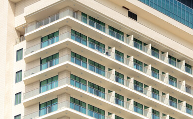 Multi-storey building with windows as background. Text