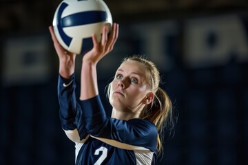 A young female volleyball player stands confidently with a volleyball in her hands. She is dressed in a team uniform and appears focused and ready for the game.