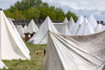 White medieval tents in nature in summer