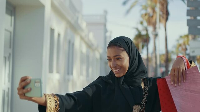 Cinematic image of a beautiful woman from Dubai wearing black abaya dress and walking in the city center and doing shopping.