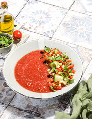 gazpacho food styling on a tile background