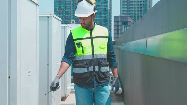 Engineer under checking the industry chilled water fan coil unit air conditioner is water cooling tower air chiller HVAC system of large industrial building to control air system
