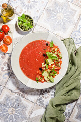 gazpacho food styling on a tile background