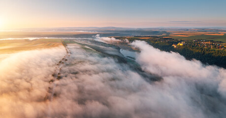 Breathtaking bird's eye view of a misty valley covered in fog. Dniester canyon, Ukraine, Europe.