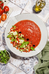 gazpacho food styling on a tile background