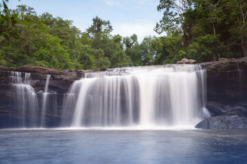 Fototapeta premium The source of the river in the forest. waterfall with forest in the background.Lake waterfall , Mountains trees Nature.The beautiful peguche waterfall flowing.