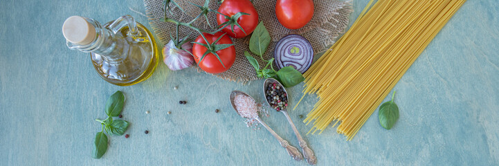 Banner of ingredients, spaghetti, red ripe tomatoes, olive oil, green basil, parmesan cheese, onion, garlic and spices. pasta recipe with tomatoes or pasta al pomodoro. flat lay on wooden background