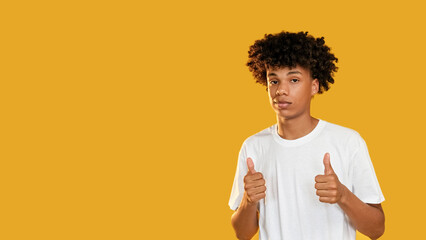 Like gesture. Positive feedback. Satisfied guy approving good idea perfect choice with thumb up isolated on yellow empty space background.