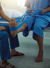 Physical therapists work with patients in close-up clinics. The concept of rehabilitation of physical health, the doctor gives advice to the patient. Ankle problems and muscle injuries