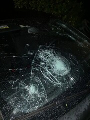 damaged and broken car windshield after violent hailstorm in italy. High quality photo