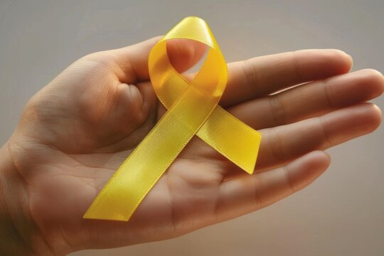 Yellow ribbon symbolizes cancer awareness  emphasizing prevention for children.